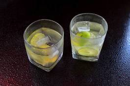 Naklejka lemonade served on a dark marble bar with a lime