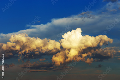 Naklejka Fluffy clouds at sunset