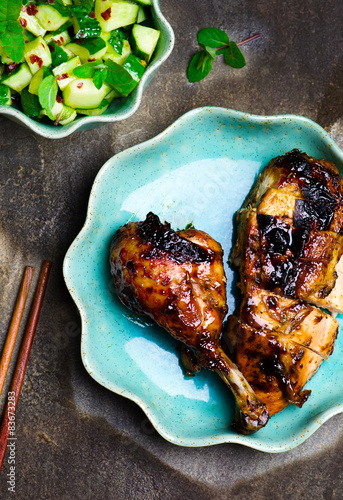 Obraz na płótnie the chicken baked in Asian style and cucumber salad