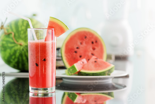 Naklejka Glass of fresh watermelon juice on kitchen table
