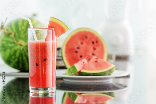 Plakat Glass of fresh watermelon juice on kitchen table