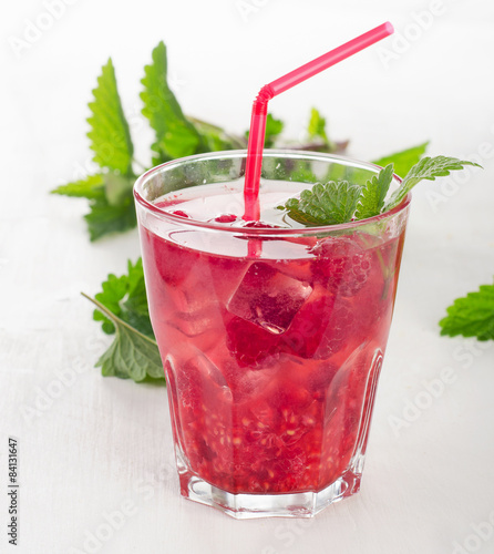 Naklejka Summer cold drink with raspberries, ice and mint .