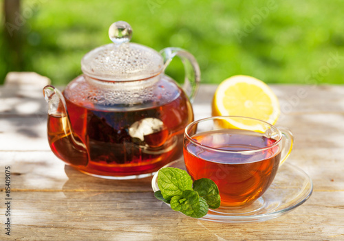 Fotoroleta Breakfast tea on table in garden