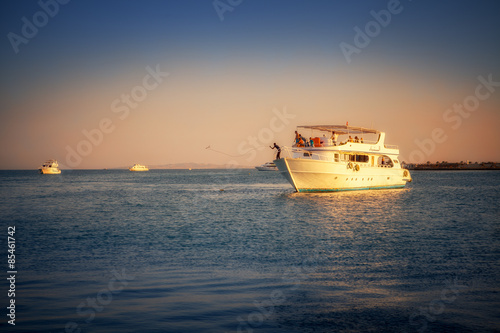 Plakat jacht łódź statek morze czerwone słońce