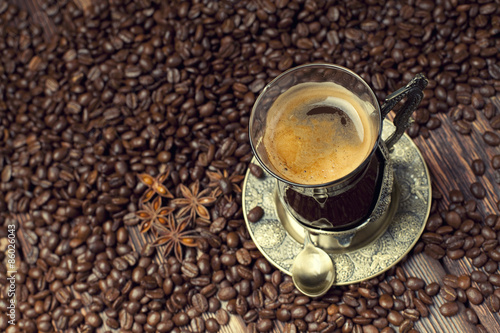 Naklejka Coffee cup on coffee grains background