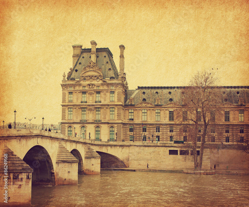 Naklejka Seine. Bridge Pont Royal in central Paris, France. Photo in retro style. Added paper texture. Toned image
