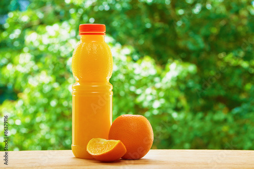 Plakat Orange and juice on the table