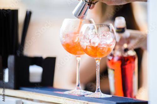 Fotoroleta Barman preparing a cocktails/Barman added ingredients in a cocktail