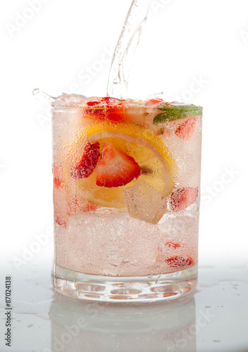 Naklejka Seltzer Drink with Fresh cut fruit floating inside